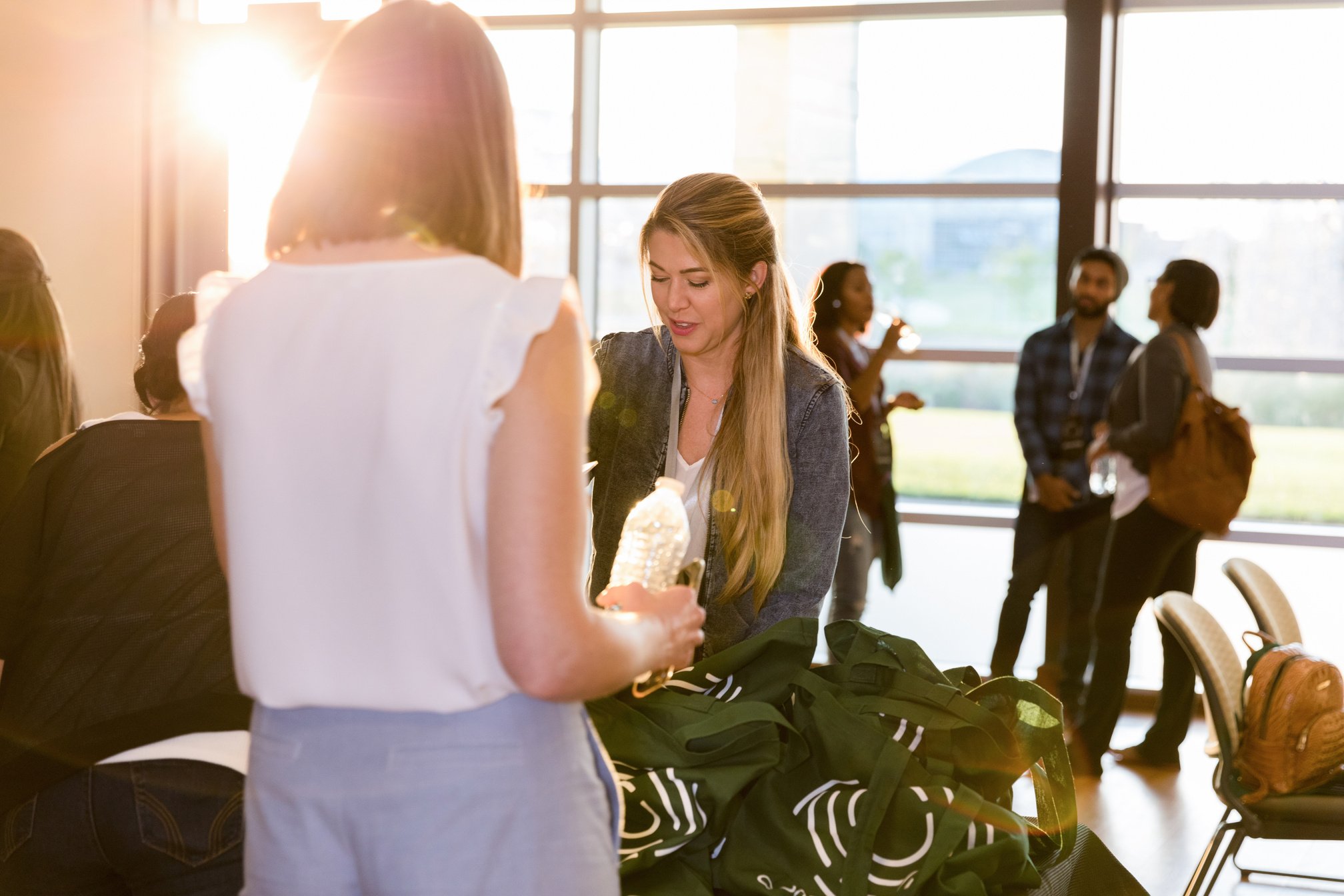 Mid adult businesswoman works at conference registration